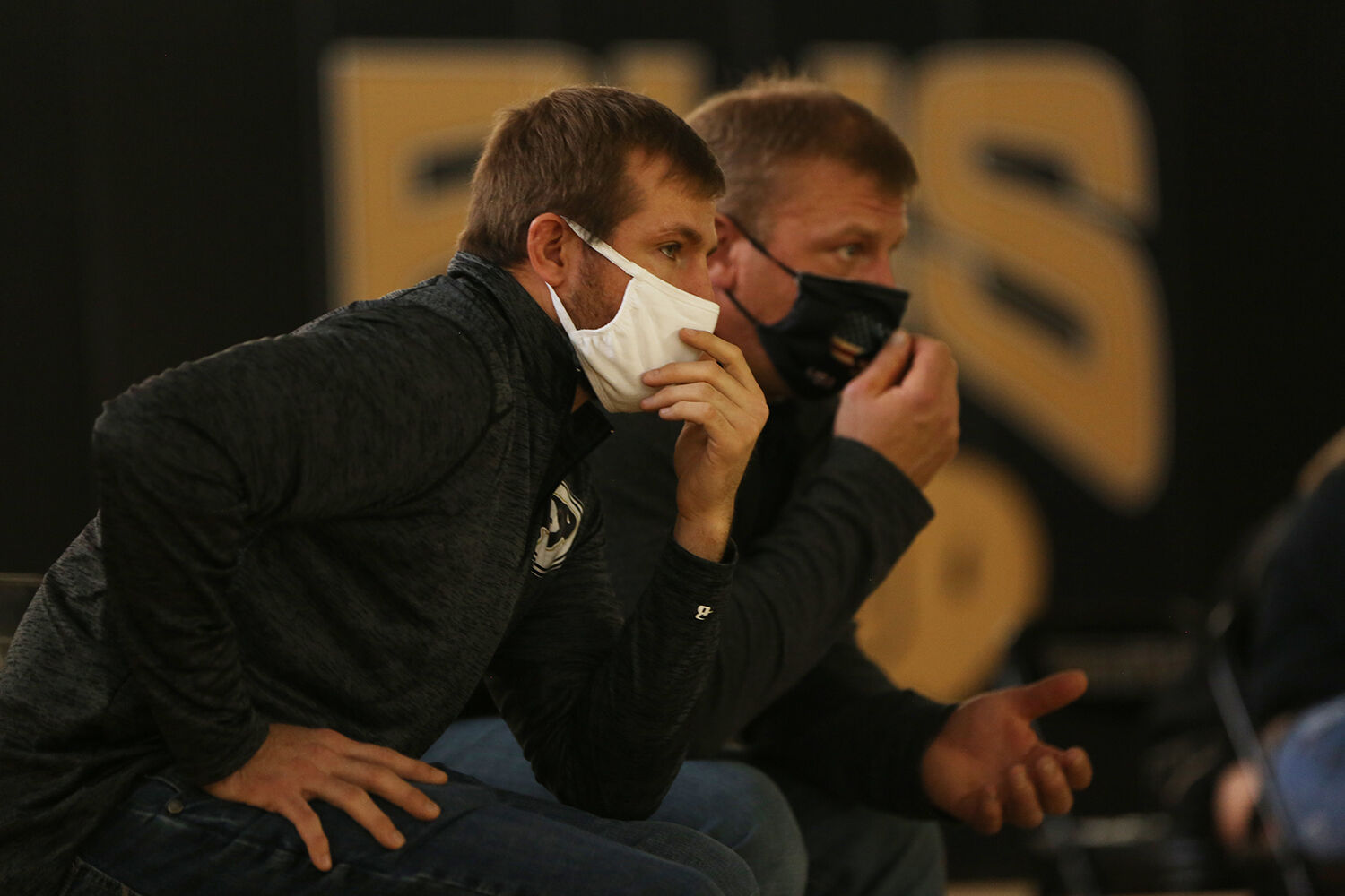 Garrett Traylor, front, and Jason Tomich watch sophomore Teila Peters